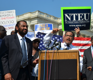congress people standing together at a podium