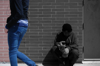 person walking by ignoring the homeless