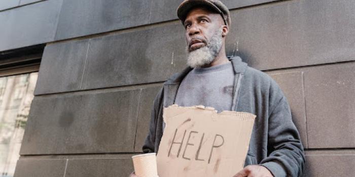 man holding sign that says help