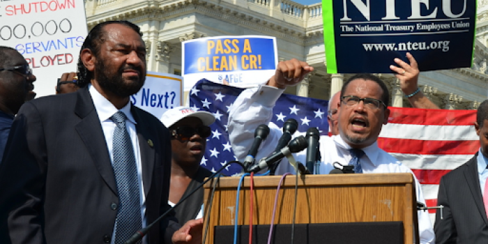 congress people standing together at a podium