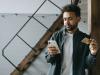 Man holding cell phone in one hand and credit card in the other