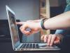 Fingers touching laptop
