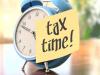 Alarm clock with "tax time" sticky note