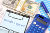 Calculator cash and a form that reads credit report