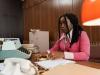 Woman counting cash at desk