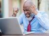Man frustrated in front of computer