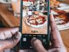 phone taking picture of pizza