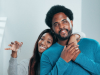 Couple hugging, holding home keys