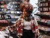 black woman in record store shopping 