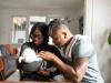 two black parents looking at their baby