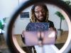 black man holding a printed chart of stocks