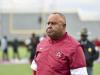 buddy pough on the playing field in coaching gear