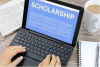 laptop that says scholarship across the top