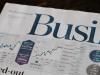business newspaper with a graph that has a rising line