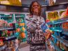 black person snacking on chips in a convenience store