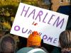 sign held up that says harlem is our home