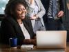 black woman smiling at computer