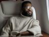 man wearing eyeglasses inside an airplane looking through the window