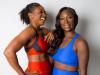 two black women standing together in sports wear