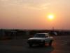 car driving with the sun setting