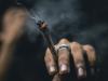 person holding a joint in between their fingers